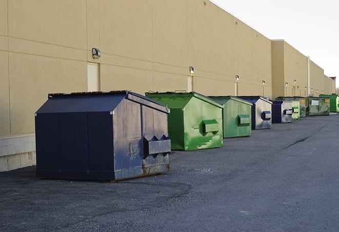 multiple construction dumpsters at a worksite holding various types of debris in Charlottesville